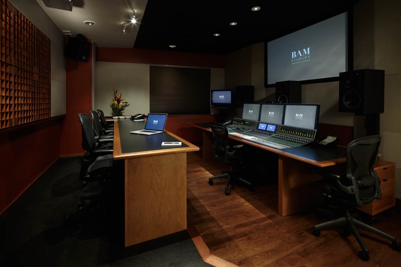 Studio B control room — console, client desk, and the diffusor wall