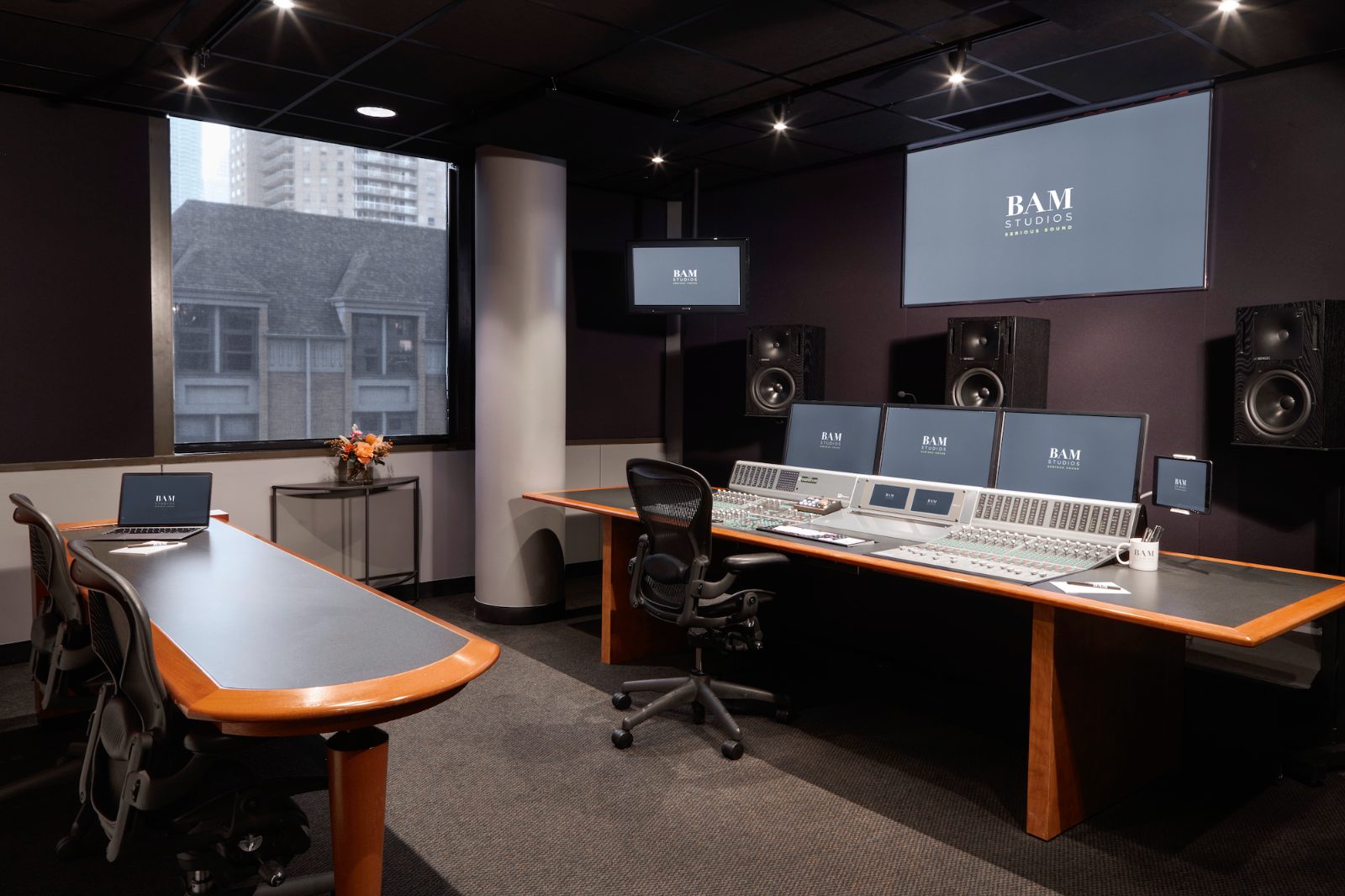 Studio D control room — console, Genelec monitoring, and a window onto Erie Street