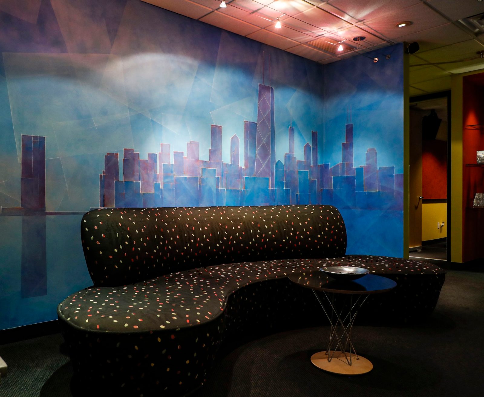The BAM lobby — Chicago skyline mural above the curved couch